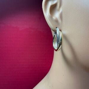 Sterling Silver JCM crossover hoop earrings. 1 inch diameter